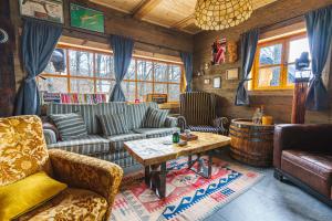 a living room with a couch and a coffee table at Brvnara Iverak in Mokra Gora