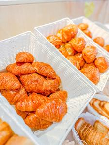 a group of croissants and other pastries in plastic containers at Hotel Le Dome in Brussels