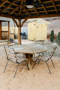 a wooden table and two chairs under a pavilion at Blythe Shoals Base Camp in Cleveland