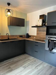 a kitchen with a sink and a stove at Location appartement estivale in Montagnac
