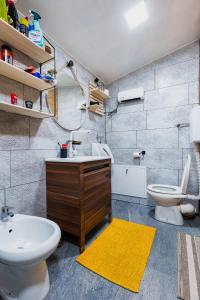 a bathroom with a sink and a toilet at Brvnara Iverak in Mokra Gora