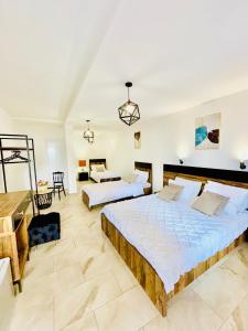 a bedroom with two beds and a living room at Hotel Lagadin in Ohrid