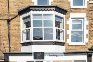 a white window on the side of a building at 3 Bed Apartment By Movida Property Group Short Lets & Serviced Accommodation Harrogate in Harrogate