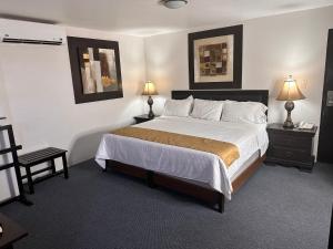 - une chambre avec un grand lit, 2 tables et 2 lampes dans l'établissement Hotel del Fresno, à Fresnillo de González Echeverría