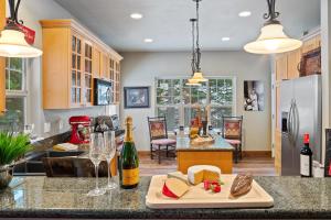 a kitchen with a counter with cheese and wine bottles at 30-Day Min Near Lake and Downtown Whitefish in Whitefish