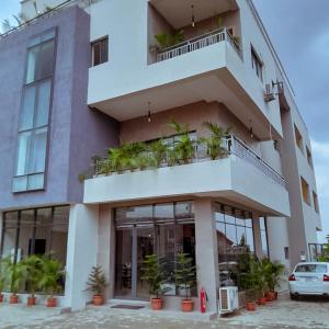 a large building with plants on the balconies at Greywood Hotel and Apartments in Ikeja