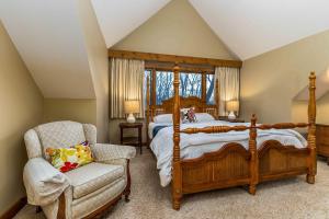 a bedroom with a large bed and a chair at 4 Bdrm Dog-Friendly Territory Getaway in Galena