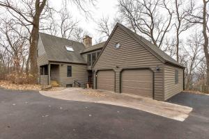 a house with a large garage in a driveway at 4 Bdrm Dog-Friendly Territory Getaway in Galena