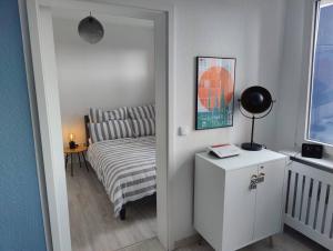 a bedroom with a bed and a table with a lamp at Stylisches Apartment im Szene-Viertel Ehrenfeld in Cologne