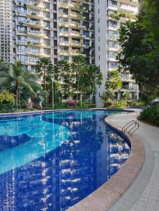 a large swimming pool with buildings in the background at Holiday SweetHome at Forest City 2BR1B with TV Box 4-6pax 1807 in Gelang Patah