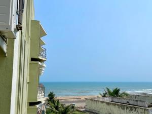 a view of the ocean from a building at Hotel TBS - all-rooms-sea-view, Swimming-pool, fully-air-conditioned-hotel with-lift-and-parking-facility breakfast-included in Puri