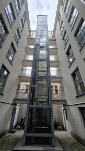 a glass elevator in front of a building at Perfect Location Comfort Apartment City Beat#10 in Krakow
