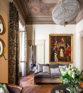 a living room with a couch and a painting at This Time Tomorrow in Florence in Florence