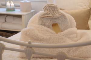 a snow man sitting on a couch with a blanket at Orkney Retreats 1 2 and 3 bedroom Island Farmhouses & Cottages in Sanday