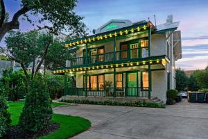 a house with lights on the front of it at Greenhouse Uptown in Dallas