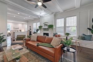 a living room with a couch and a fireplace at Greenhouse Uptown in Dallas