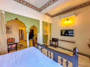 a bedroom with a bed and a staircase with a tv at DYORE House in Jaipur