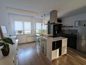 a kitchen with a kitchen island with a counter top at APARTAMENTO RECONQUISTA in Toledo