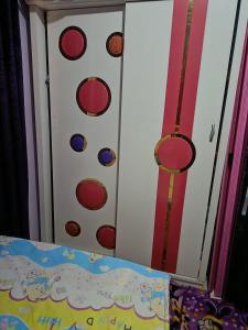 a door with a snowman face on it next to a bed at شقه فندقيه in ‘Ezbet el-Insha