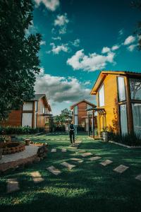 a person walking in a yard next to a house at Pousada Capanna del Vale - Vale dos Vinhedos in Bento Gonçalves