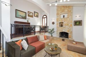a living room with a couch and a fireplace at Kalami Lookout Villa in Kalami
