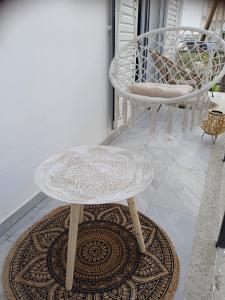 a table and two chairs on a patio at Mirto Luxury Appartment in Heraklio Town