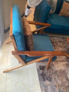 a wooden rocking chair in a living room at Barryston Haven 1 in Kampala