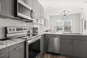 a kitchen with stainless steel appliances and a microwave at New Building Downtown Atlanta Condo in Atlanta