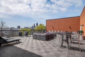a patio with a table and chairs on a building at New Building Downtown Atlanta Condo in Atlanta