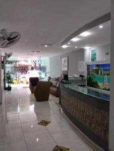 a lobby with a counter with a fish tank at Ayenda Zhena in Cúcuta