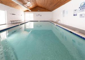 a large indoor swimming pool with blue water at Community Private Beach on Whitefish Lake and About a Mile to Downtown in Whitefish