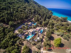 an aerial view of a house on a hill next to the ocean at Arenaria L. Villas Complex in Lefkada Town