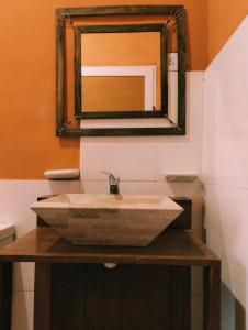 La salle de bains est pourvue d'un lavabo et d'un miroir. dans l'établissement Hostal La Casa, à Aicuña
