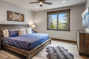 a bedroom with a bed and a window at LUXURY SKI-IN-OUT Mid-Mountain Game Room Hot Tub in Whitefish