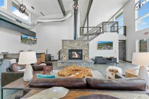 a living room with leather furniture and a fireplace at Luxury Amenities with a Central Location to Downtown and Whitefish Mountain Resort in Whitefish