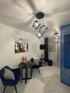 ヤレムチャにあるApartmets Club Yaremcheのリビングルーム(テーブル、椅子、照明付)