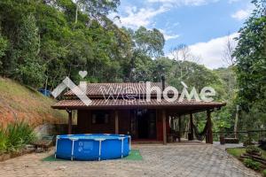 ein Gebäude mit einem Schild, das nach Hause geht in der Unterkunft Casa com área de lazer e vista para as montanhas in Aguas Mornas
