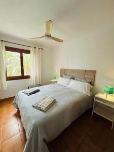 een slaapkamer met een groot bed en een ventilator bij Apartamento Buganvilla Pool in Muntanya la Sella