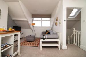 a living room with a couch and a table at Cozy 1 Bedroom Apartment | WIFI in Cardiff