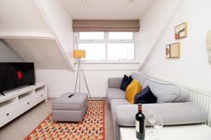 a living room with a couch and a tv at Cozy 1 Bedroom Apartment | WIFI in Cardiff