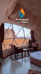 a room with a bed and a window with a view at RUM iSLAND LUXURY CAMP in Wadi Rum
