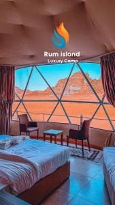 a room with a bed and a view of the desert at RUM iSLAND LUXURY CAMP in Wadi Rum