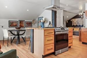 a kitchen with a stove and a table with chairs at Spacious Studio Unit 5 with Gorgous Canyon Views in Durango