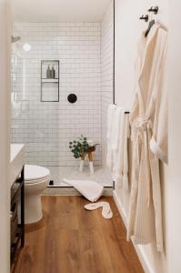 a white bathroom with a toilet and a shower at El Dorado Hotel in Sonoma