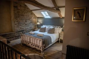 a bedroom with a large bed with towels on it at The Coach House in Longwitton