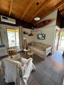 a living room with a bed and a couch at Casa Monte Hermoso / Sauce grande in Balneario Sauce Grande