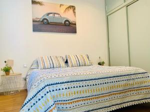 a bedroom with a bed with a picture of a car on the wall at F2 port de canet in Canet-en-Roussillon