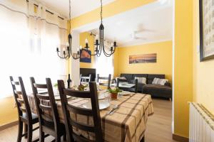 a dining room and living room with a table and chairs at Vincent's House in Barcelona