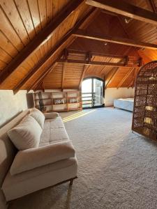 a living room with a couch in a attic at Top Hill Balaton in Badacsonytomaj