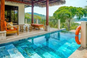 a pool at a villa with a water slide at Canto Del Mar #13 in Dominical